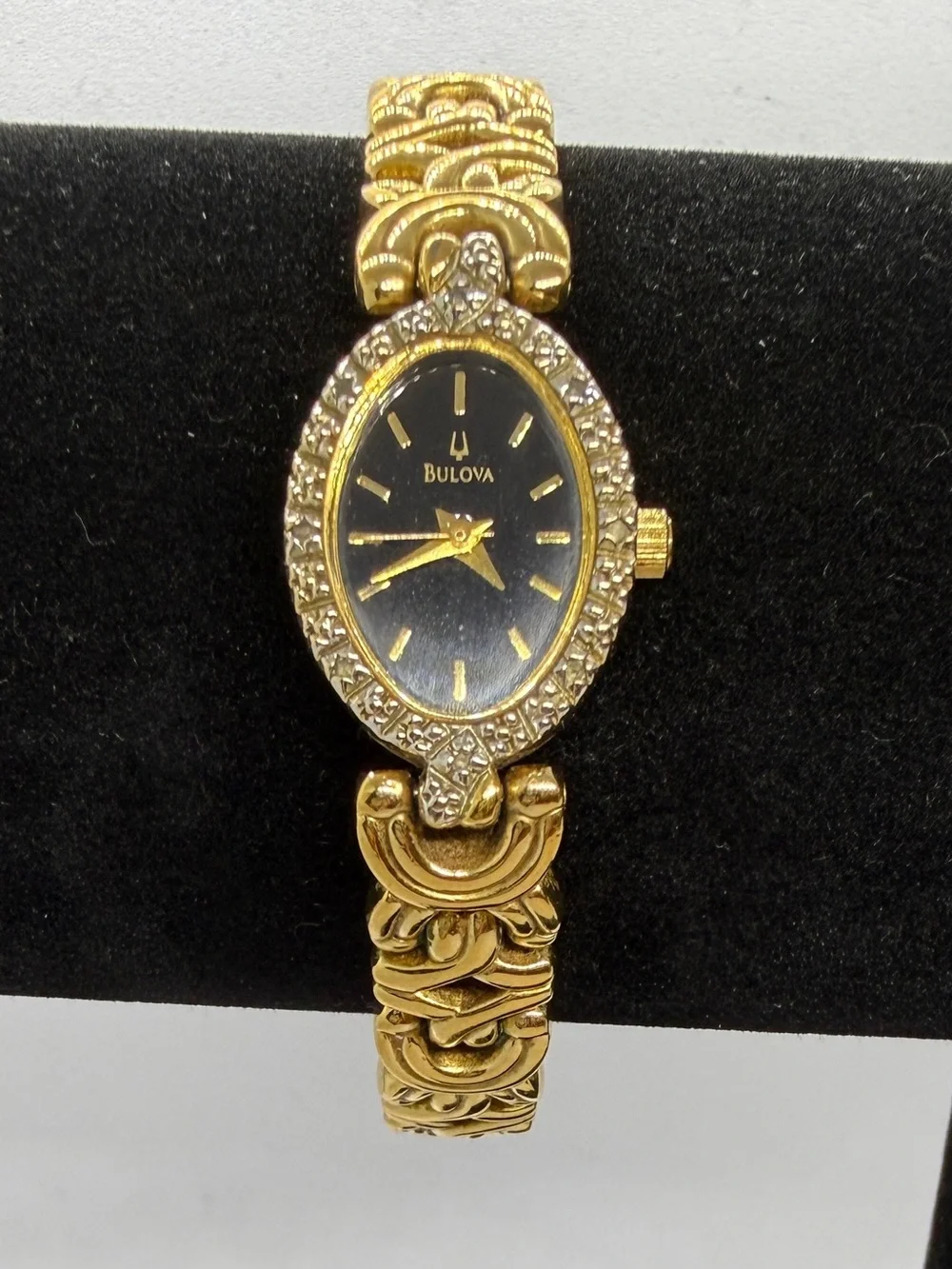 Bulova Gold Tone Dainty Oval Wristwatch Black Dial Textured Bezel Link Bracelet